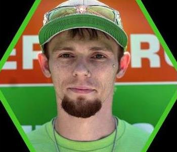 Male SERVPRO employee with a green shirt.