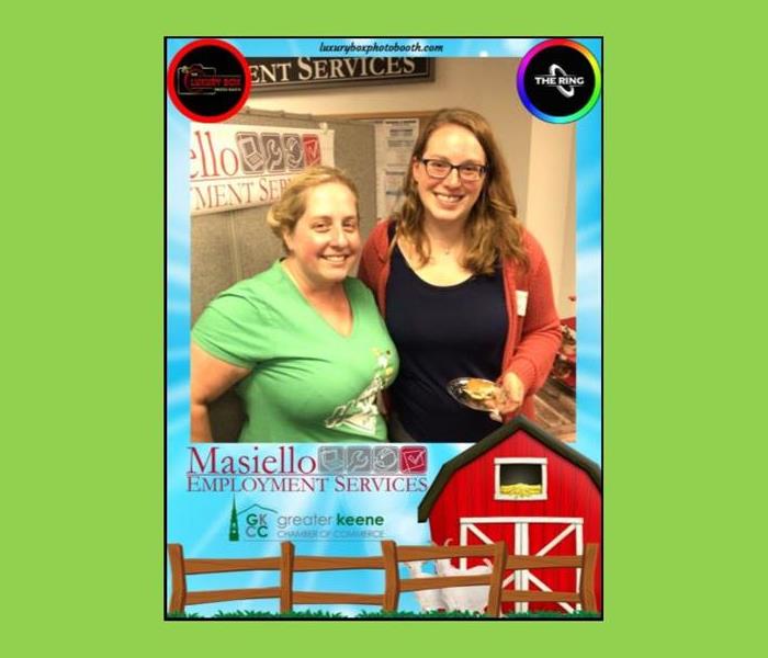 two women at networking event with frame around picture featuring branding graphics for affiliated companies from event.