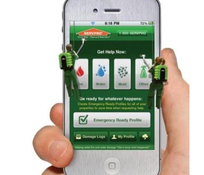 Smart phone with SERVPRO ERP app open with a hand holding the phone.