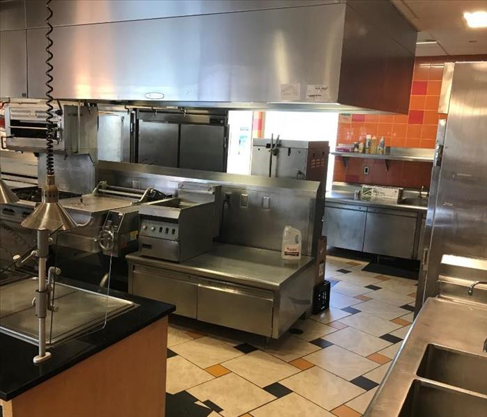 Commercial kitchen including sinks, refrigerators, cooktops and other cooking equipment.