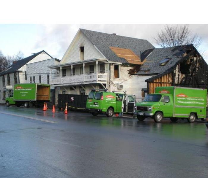 SERVPRO trucks parked outside of a commercial fire job.